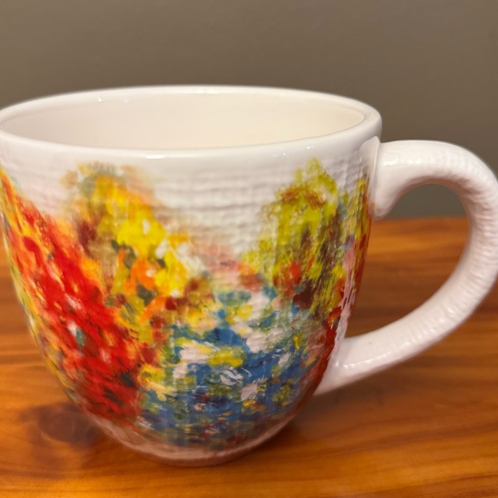 Pier One colorful mug with red, blue, yellow artistic design.